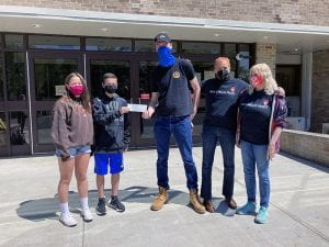 NJHS officers hand donation to Nyack Homeless Project representatives