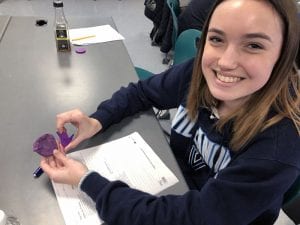 Student smiling holding chocolate mold
