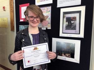 Student artist with certificate and photograph