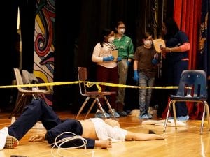 Students and scientist work on mock crime scene