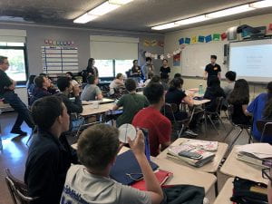 High school teachers teaching lesson to eighth-grade math class