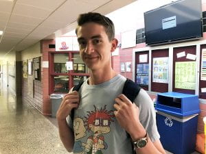 Eagle Scout Patrick Daly standing with backpack in high school hallway