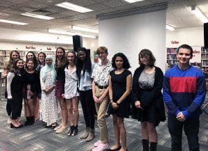 English honor society members and advisor standing in a line in the school library