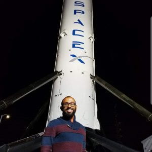 Joval Mathew ('12) in front of SpaceX rocket