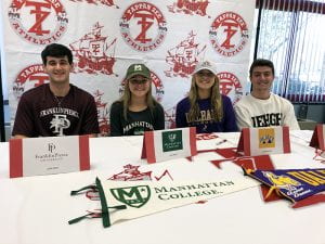 Student-athletes in college gear for NLI Signing Day