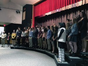 2019 National Honor Society inductees stand on risers at TZHS