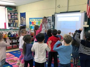 Teacher showing children the letter W.