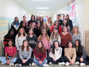 Interact Club group photo - students sitting, kneeling and standing