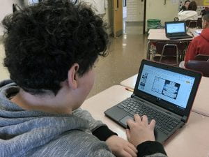 Male student with constellation graphing project on screen