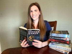 Stephanie Stehly with stack of dystopian novels