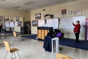 Choral Teacher Russell Wagoner teaching in front of smartboard