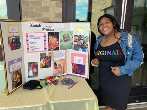 Seventh-grader with Poetry Cafe display board