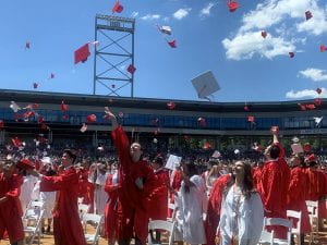 TZHS students toss caps in the air at graduation