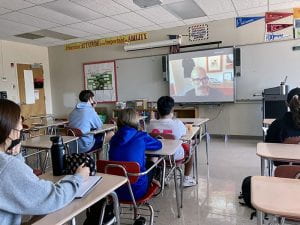 Students watch virtual speakers