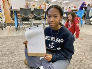 Fifth grade student with drawing of Ruth Bader Ginsburg